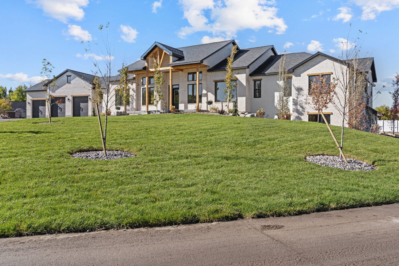 560 Partridge Lane front exterior — new construction all-brick home on full acre corner lot in Quail Hollow Estates Rexburg Idaho
