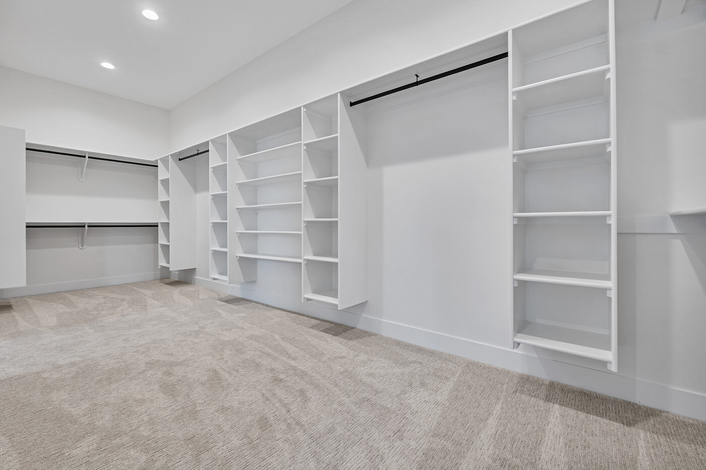Massive walk-in closet with built-in organization system — primary suite